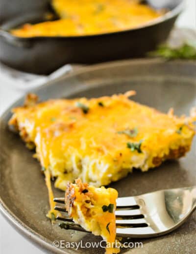 Cheesy Chorizo Frittata on a a plate with a fork with some frittata on it