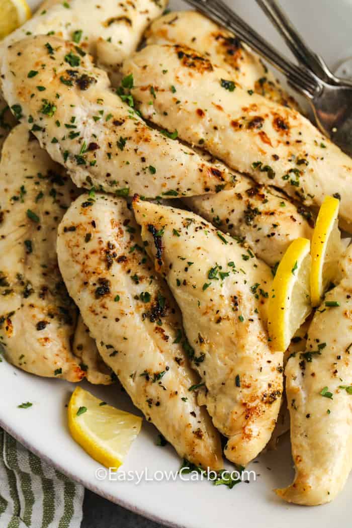 Low Carb Chicken Tenders on a plate with lemon slices