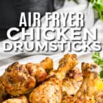 plated Air Fryer Drumsticks with air fryer in the back with a title
