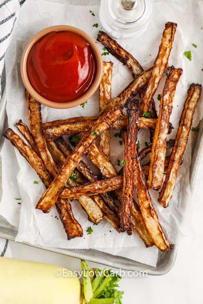 top view of Air Fryer Daikon Fries on a baking sheet with ketchup