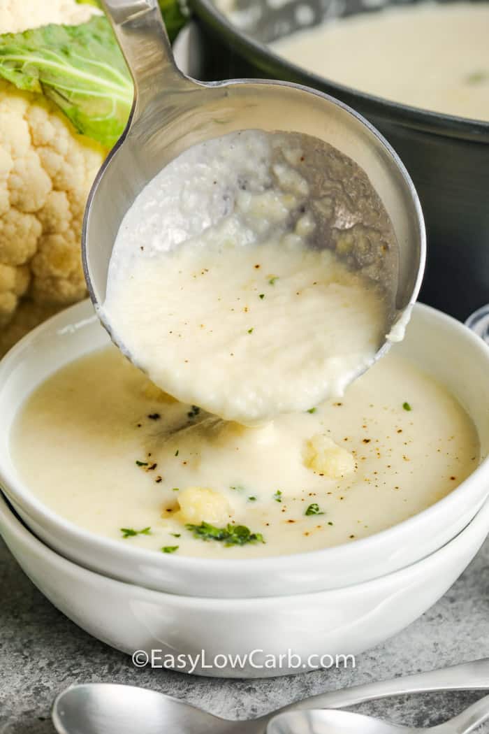 pouring Low Carb Cauliflower Soup from a laddle to a bowl