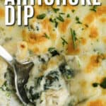 cooked Baked Spinach Artichoke Dip with a spoon and writing