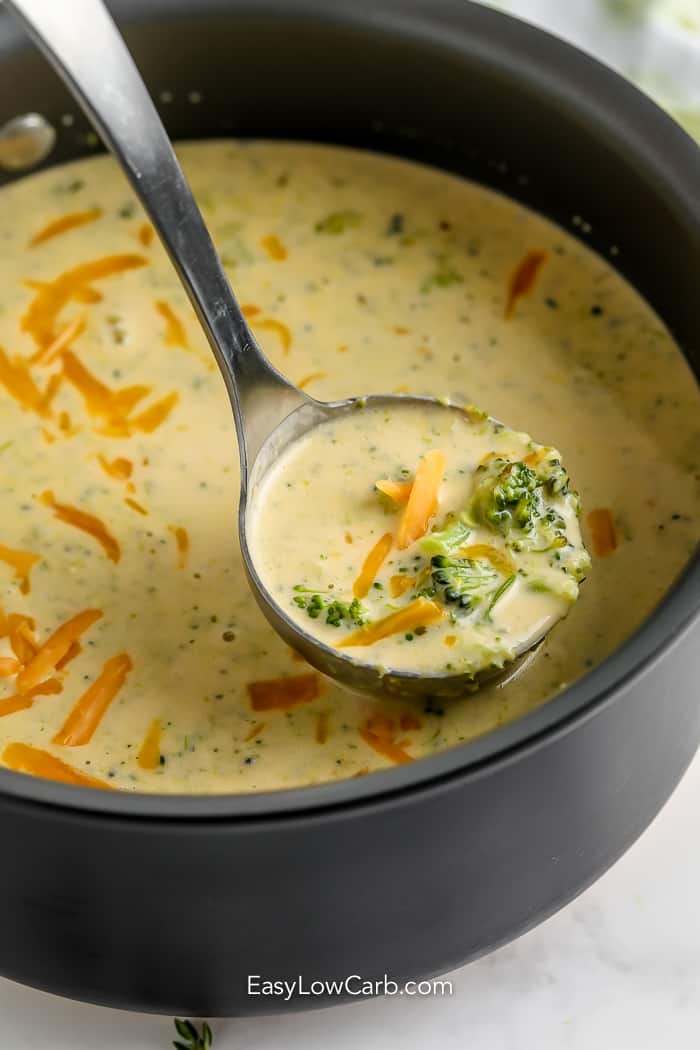 Homemade Broccoli Cheddar Soup scooped out with a silver ladel