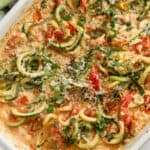 baking dish with zucchini spirals, cherry tomatoes, and feta cheese