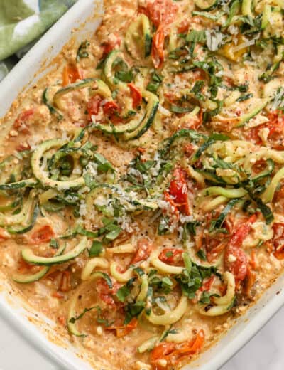 baking dish with zucchini spirals, cherry tomatoes, and feta cheese
