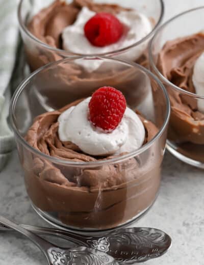 chocolate mousse in glass dishes with whipped cream