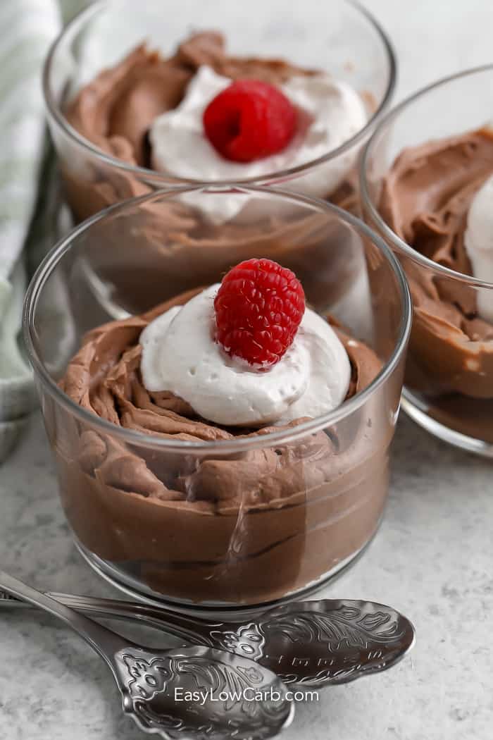 chocolate mousse in glass dishes with whipped cream