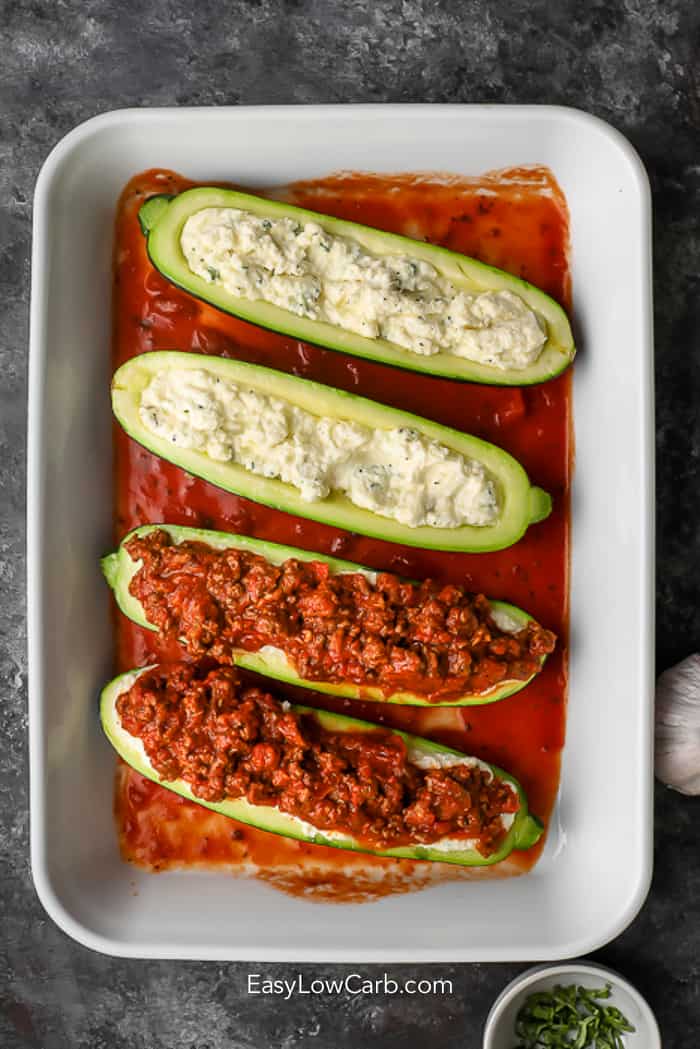 zucchini slices in white dish with sauce on them