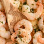 wooden spoon scooping butter garlic shrimp with text