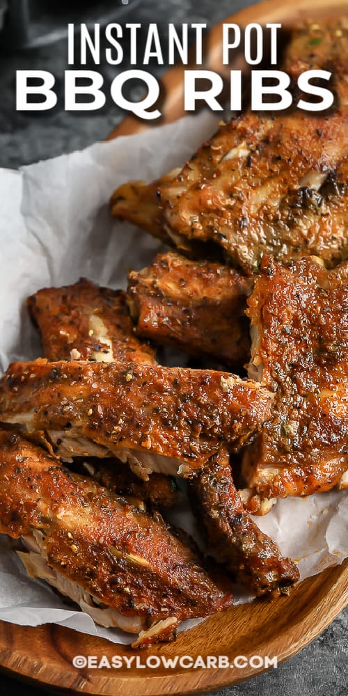 cooked ribs on a wood dish with text