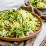 shredded brussel sprout slaw in a brown dish