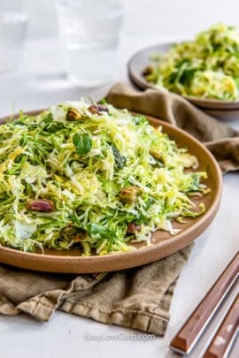 shredded brussel sprout slaw in a brown dish