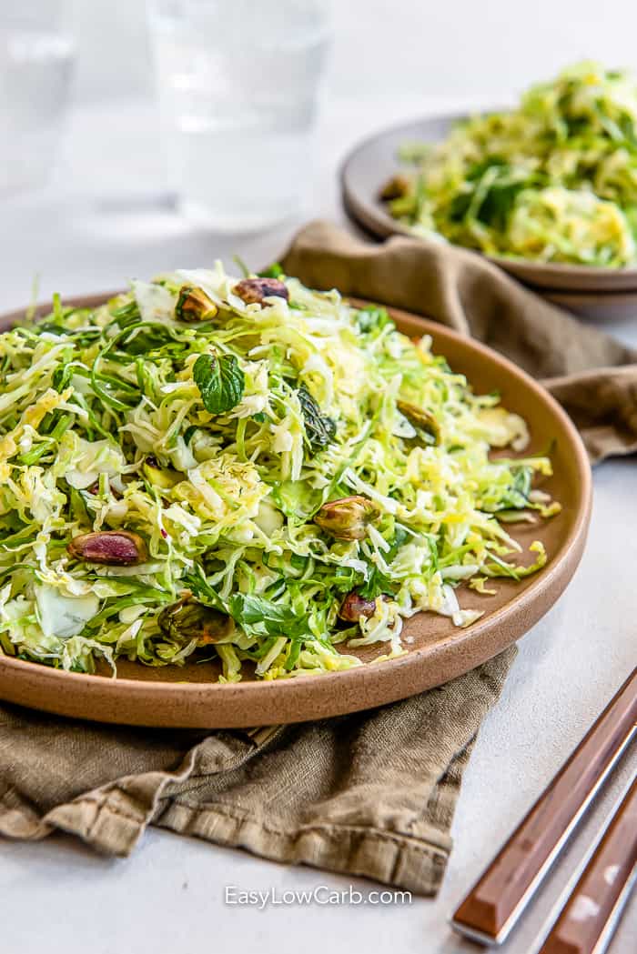 shredded brussel sprout slaw in a brown dish