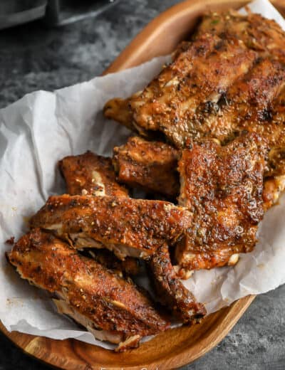 cooked ribs on a wood dish