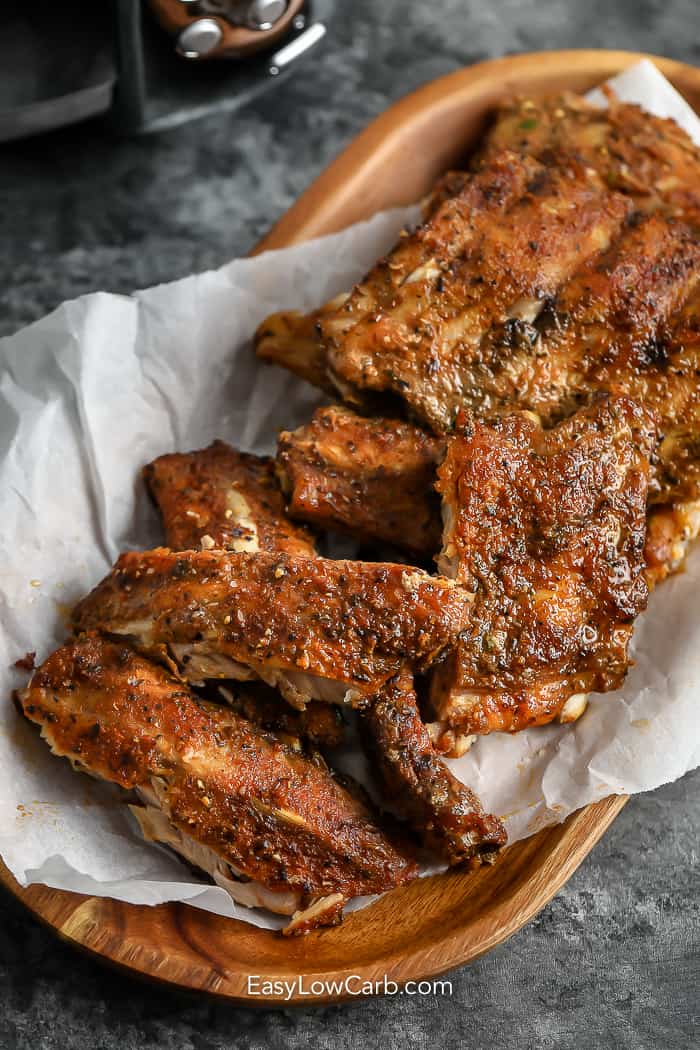 cooked ribs on a wood dish