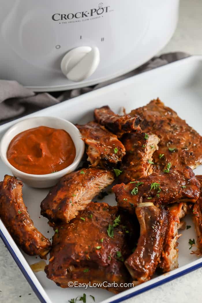 Crock Pot BBQ Ribs on a serving tray with sauce