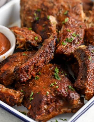 Close up of crock Pot BBQ Ribs on a serving tray with sauce