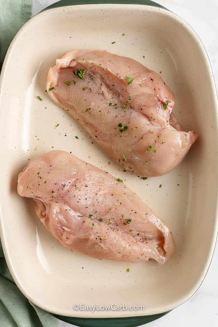 seasoned chicken breasts in a pan