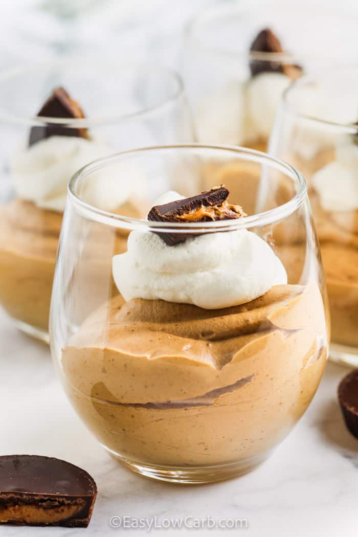 Chocolate Peanut Butter Mousse in a cup with chocolate peanut butter pieces on top