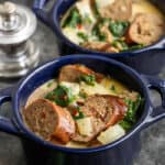 Creamy Sausage and Spinach Soup in two blue bowls