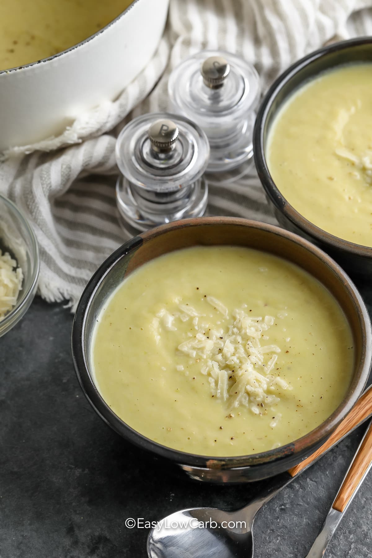 Cauliflower Leek Soup in bowls with parmesan cheese on top