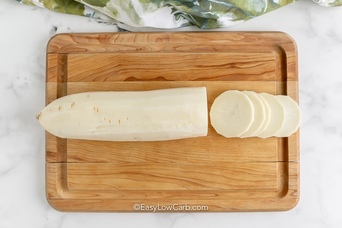 Sliced daikon on a wooden board for Keto Scalloped Potatoes
