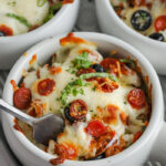 three white bowls filled with low carb Pizza Bowl Recipe, one bowl has a fork in it.