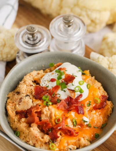 Twice Baked Cauliflower Casserole with bacon, sour cream, and green onions on top