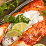 Low Carb Enchiladas topped with sour cream and cilantro with lime wedges