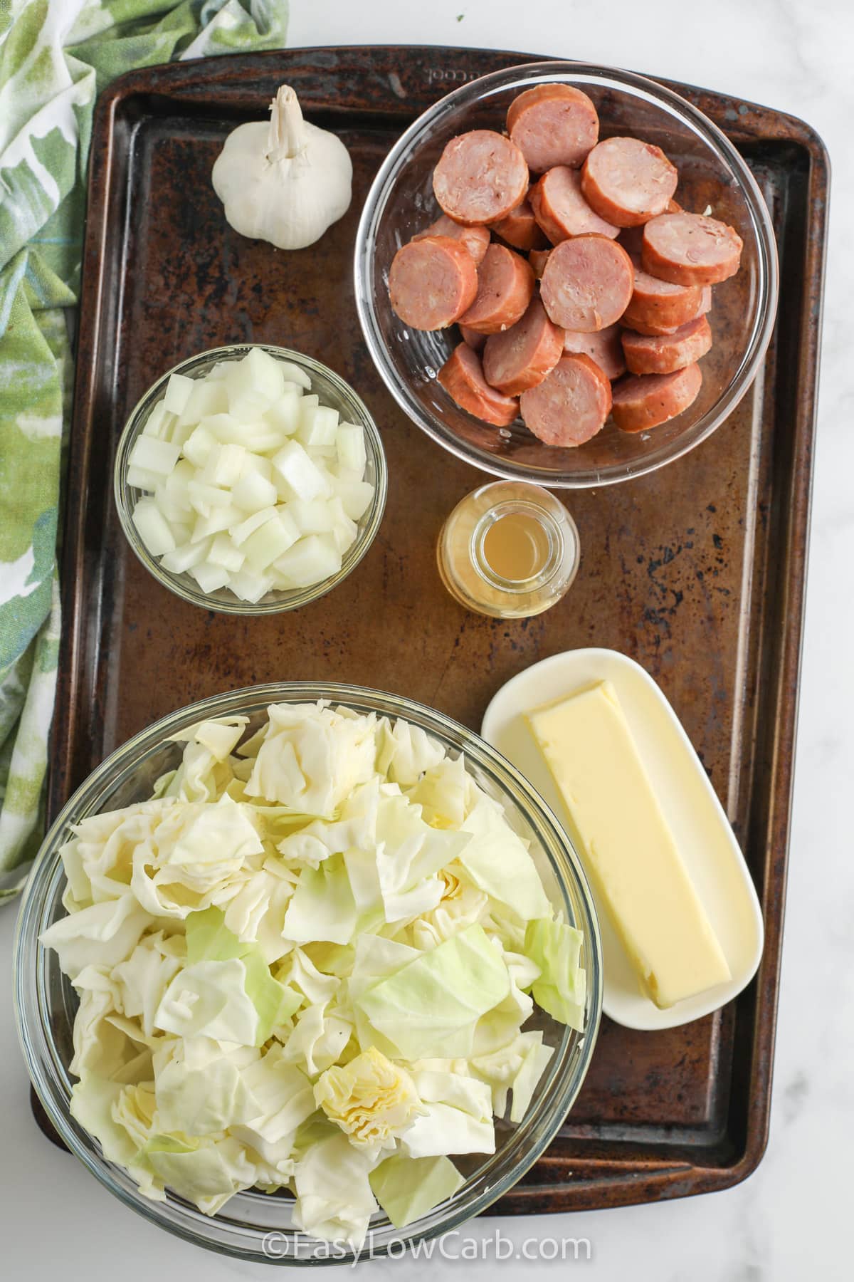 ingredients for Fried Cabbage & Sausage on a sheet pan