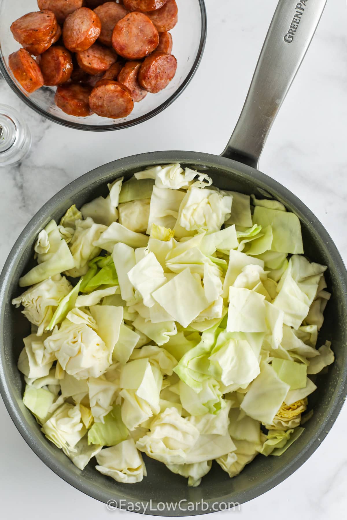 ingredients for Fried Cabbage & Sausage in a skillet and a bowl