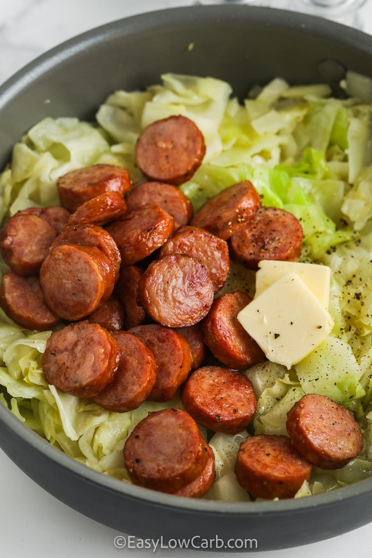 Fried Cabbage & Sausage in a skillet before being mixed.