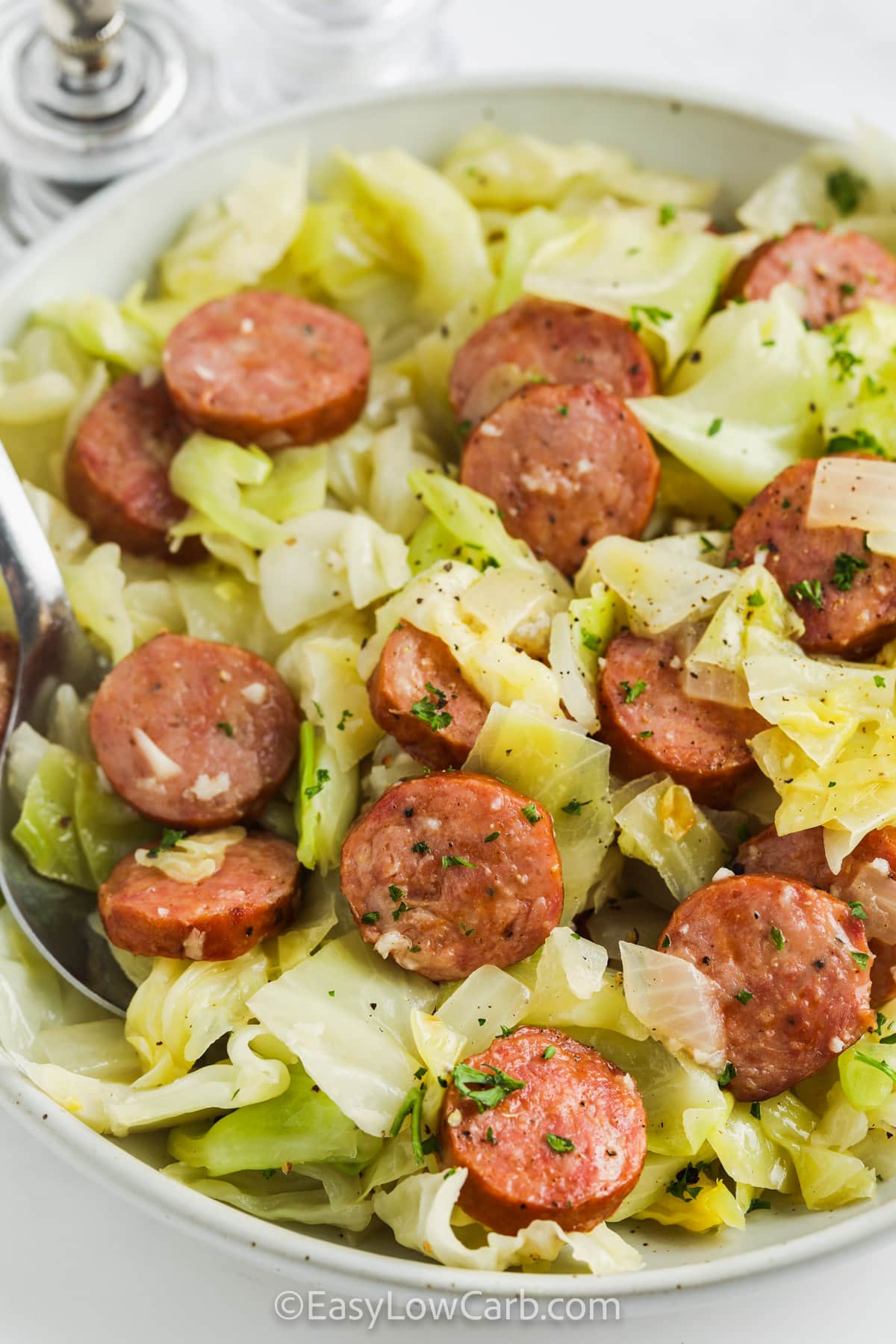 Fried Cabbage & Sausage in a white bowl