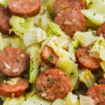 Fried Cabbage & Sausage in a white bowl with a title