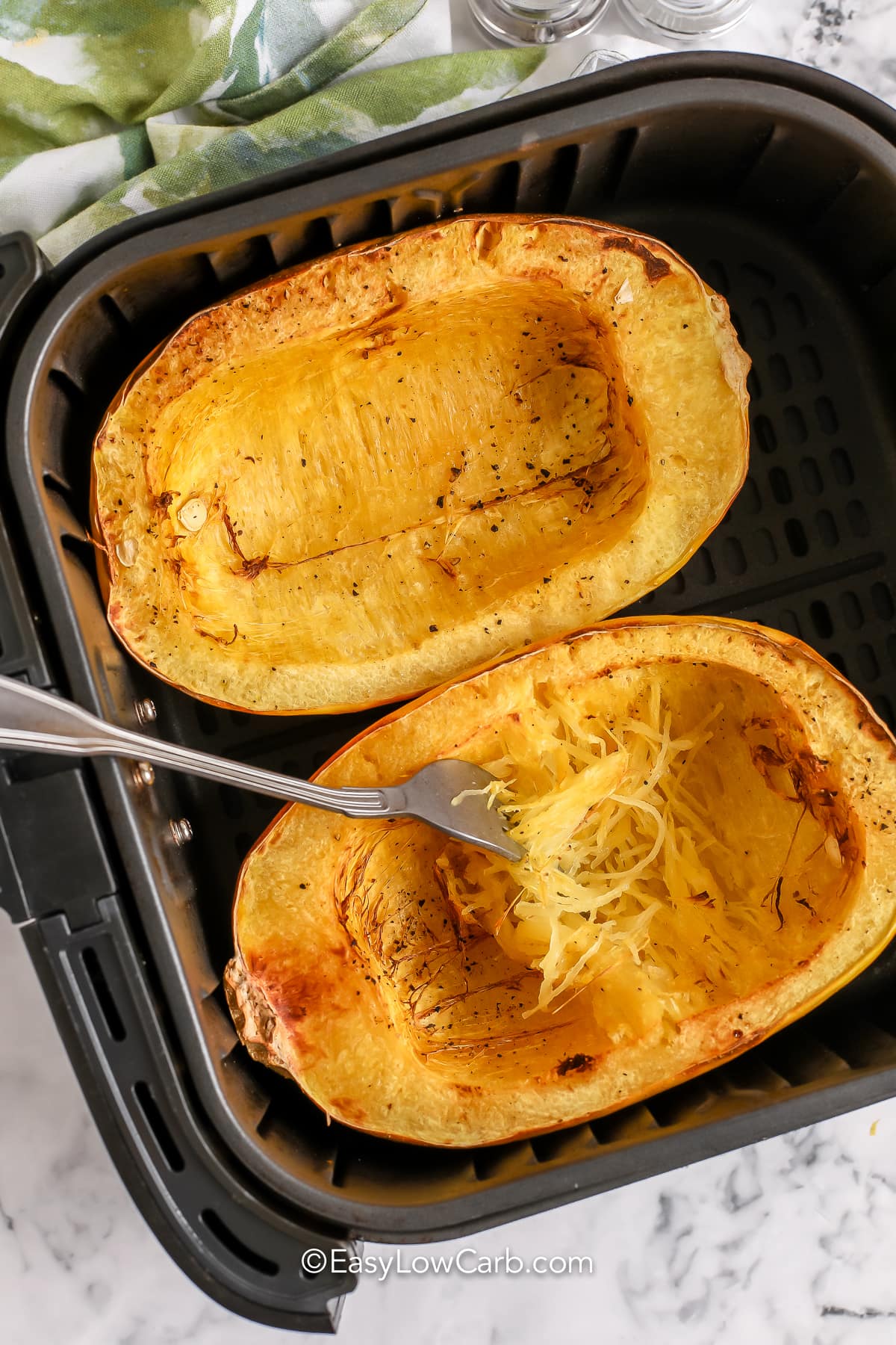 Air Fryer Spaghetti Squash in an air fryer with a fork