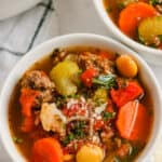 Keto Minestrone Soup in white bowls with cheese on top