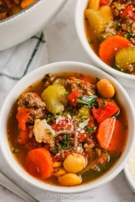 Keto Minestrone Soup in white bowls with cheese on top