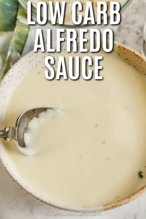 Low Carb Alfredo Sauce in a dish with a spoon and a title