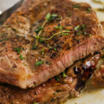 Pan Seared Pork Chops on a plate cut open to see the inside