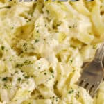 Cabbage Noodles Alfredo in a pan with a fork and a title