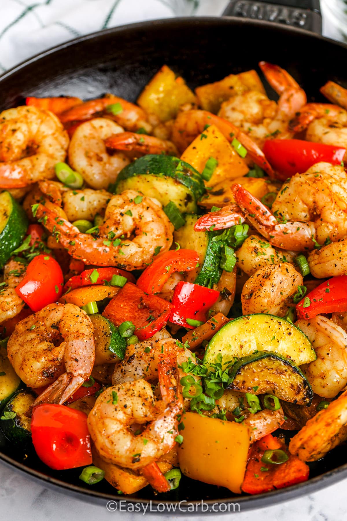 Easy Shrimp Vegetable Skillet in a frying pan with parsley and green onions as garnish