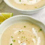 Curried Cauliflower Soup in two bowls with a title