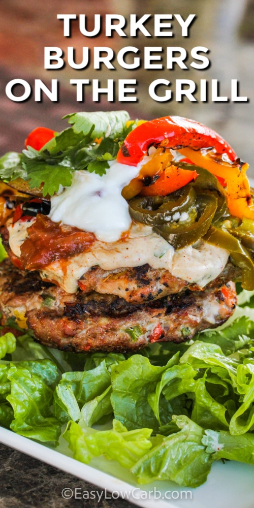 Fajita Grilled Turkey Burgers on a bed of lettuce with toppings and writing