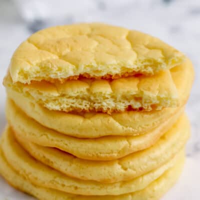 cloud bread in a stack with one ripped in half to show texture for Easy Cloud Bread Recipe