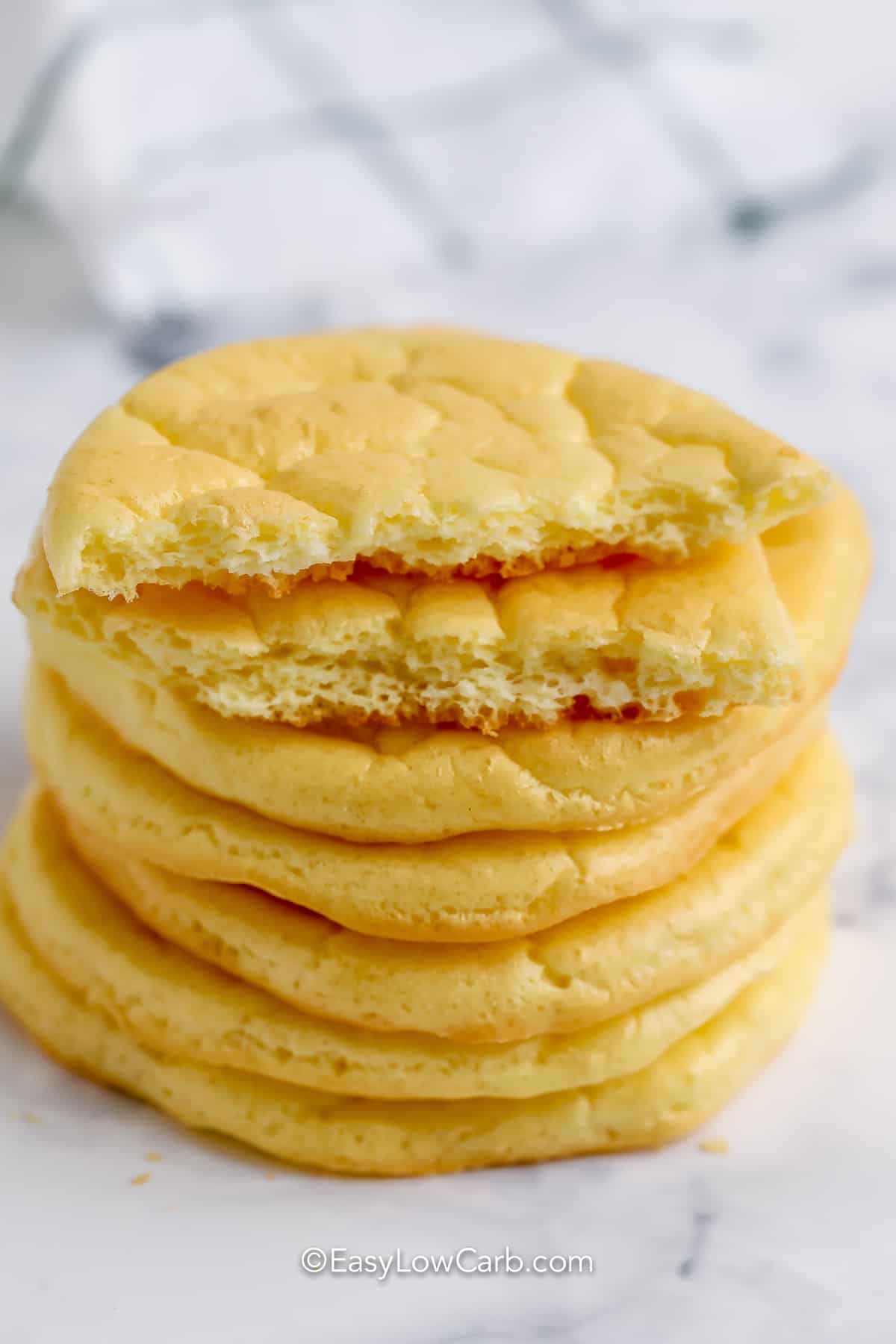 cloud bread in a stack with one ripped in half to show texture for Easy Cloud Bread Recipe