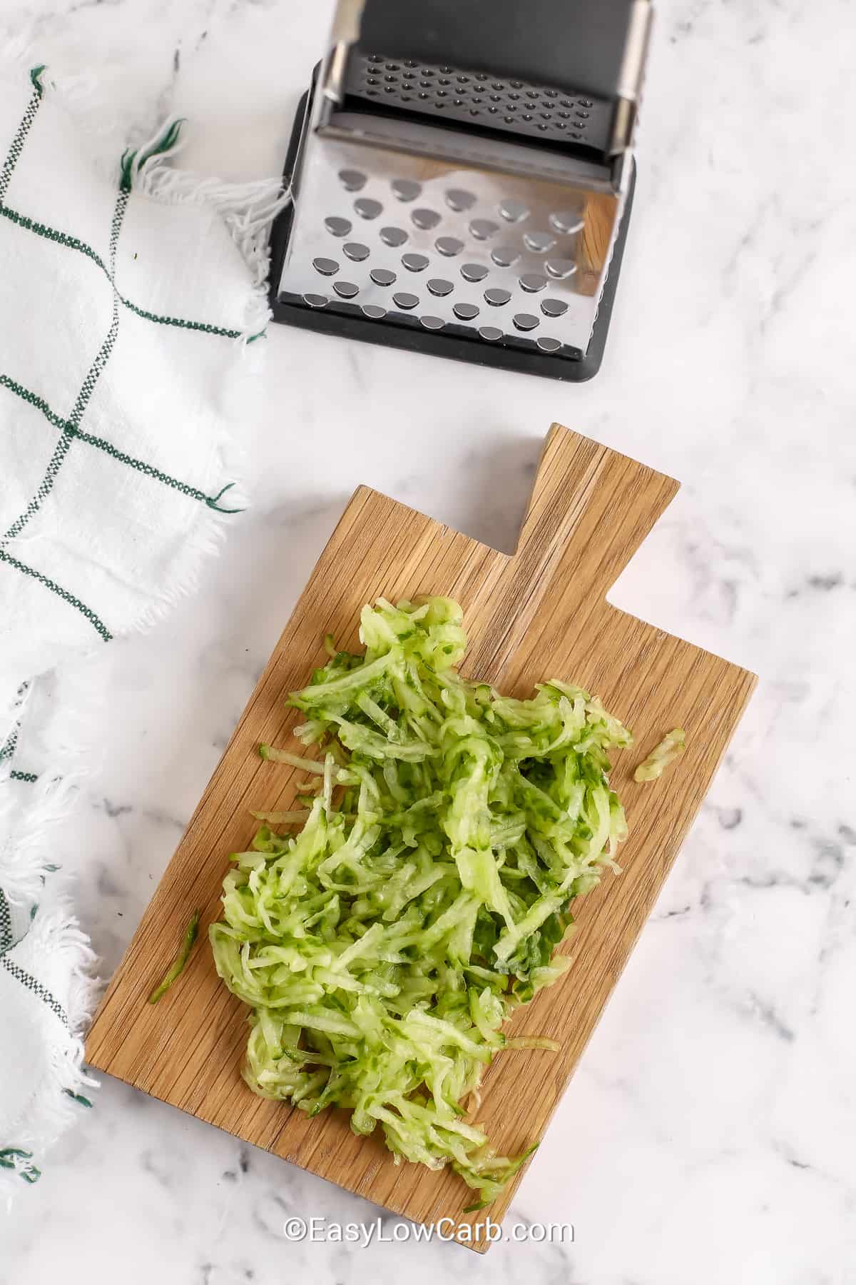 shredded cucumber on a cutting board to make homemade tzatziki
