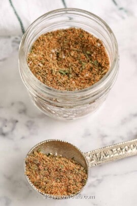 chicken seasoning in a jar and on a silver measuring spoon