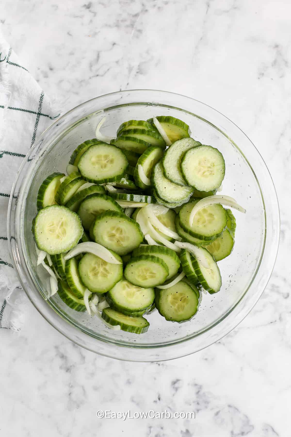 sliced cucumber and onions in a bowl