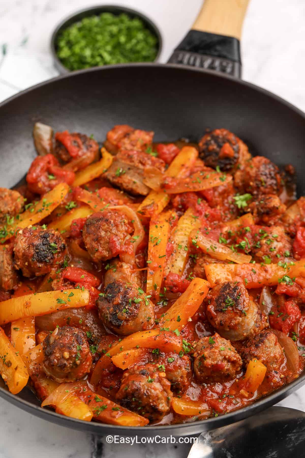 italian sausage and peppers mixed in a pan
