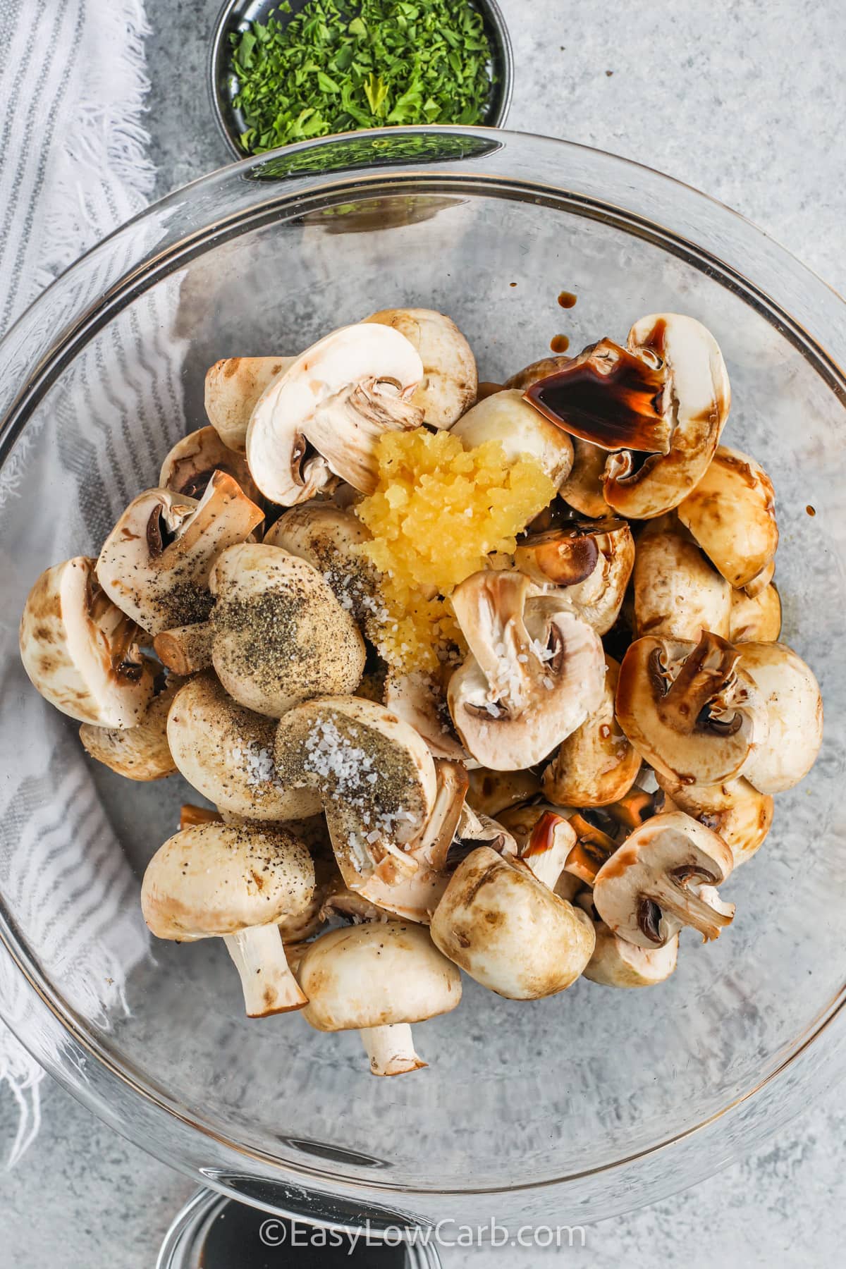 adding ingredients to bowl to make Oven Roasted Mushrooms